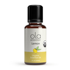Ola Botanicals Organic Lemon Essential Oil bottle with zesty aroma for fresh spaces.