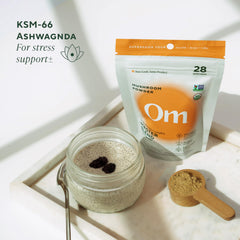 Powder being mixed into coffee or smoothie with OM Mushrooms Master Blend