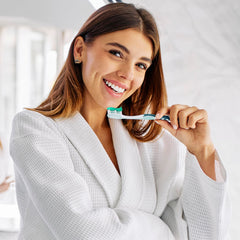 Toothpaste being applied to a toothbrush