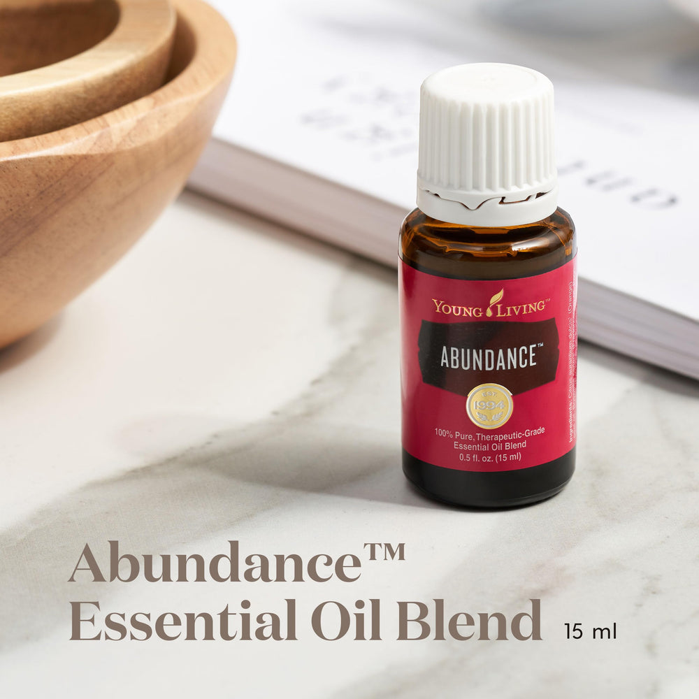 Close-up of Orange, Frankincense, and Patchouli essential oils in Abundance blend
