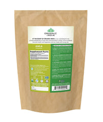 Amla powder being poured into a spoon - Organic India