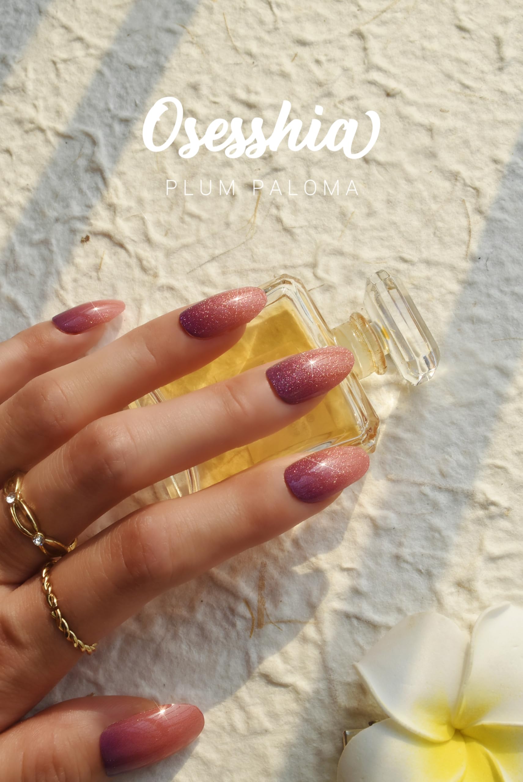 Osesshia Plum Paloma nails during application under UV light for cure