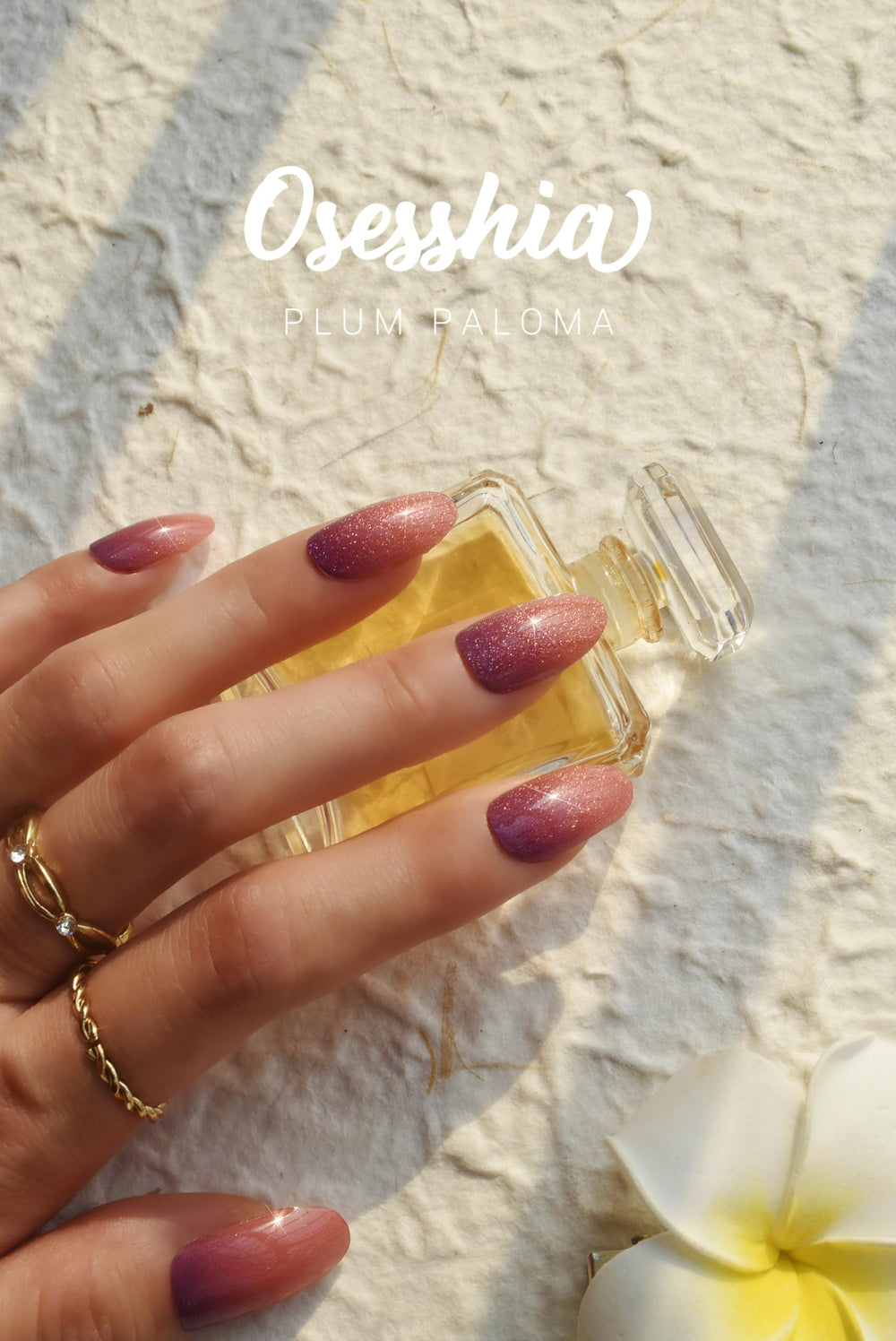 Osesshia Plum Paloma nails during application under UV light for cure