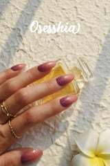 Osesshia Plum Paloma nails during application under UV light for cure