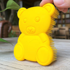 Penepico bear-yellow sensory brush front view with soft silicone bristles for gentle skin contact