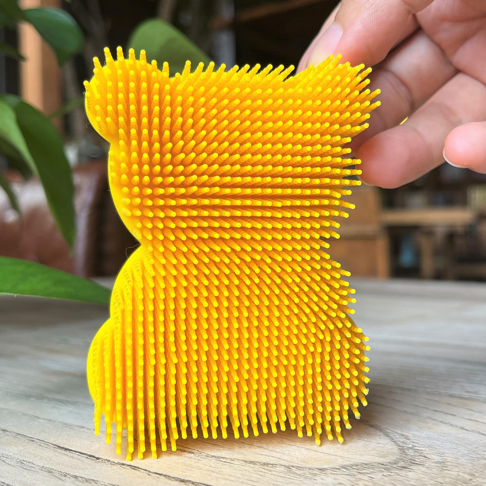 Penepico bear-yellow sensory brush side view showing two-sided design for varied stimulation