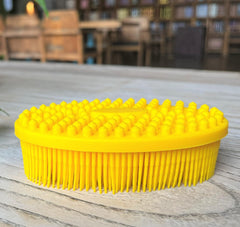 Penepico Premium Sensory Brush in oval yellow offers gentle skin contact for tactile exploration.