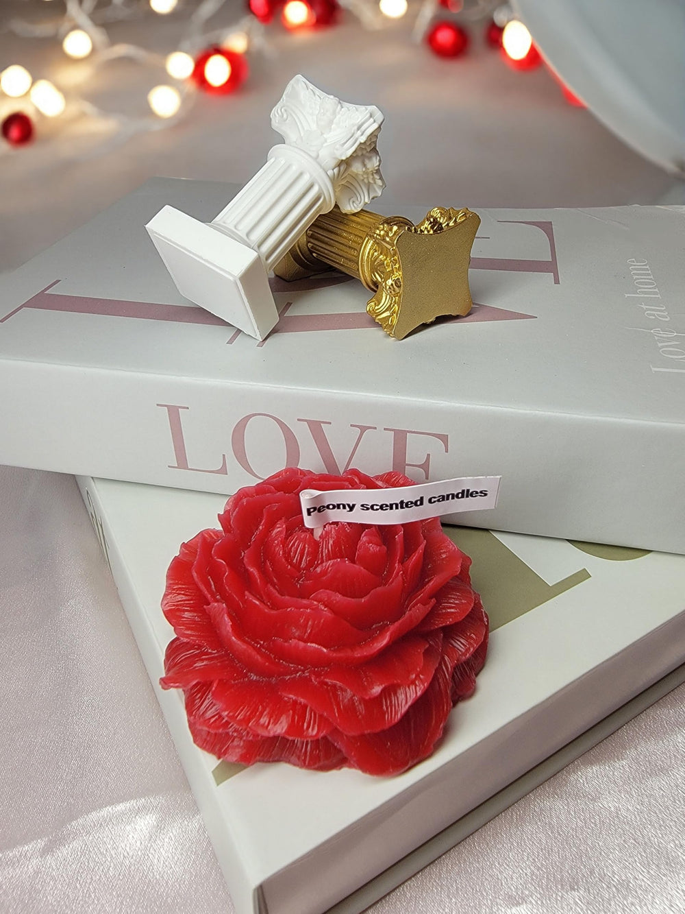 Close-up of intricate petal design on red peony candle