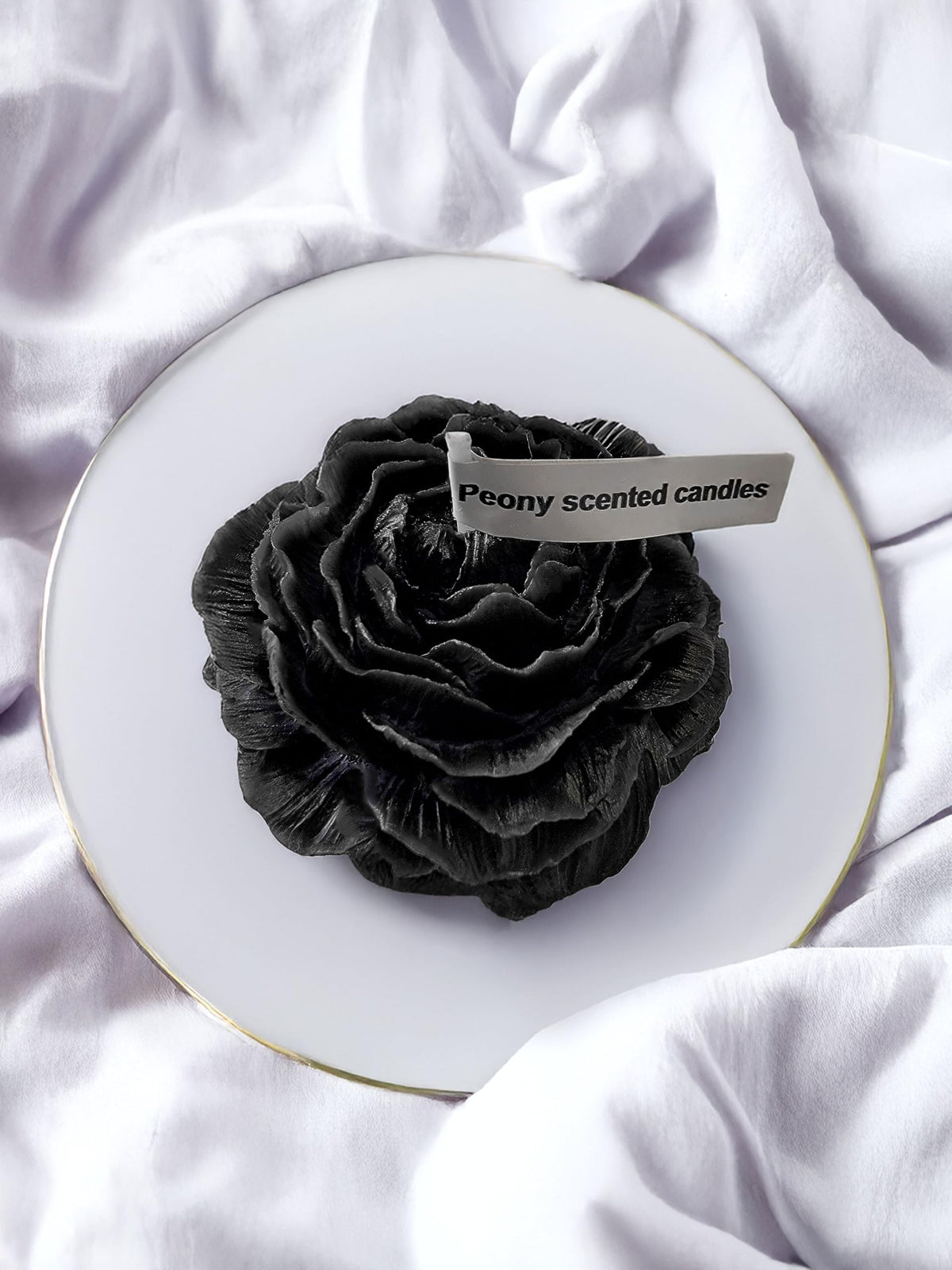 Peony flower-shaped candle in black with visible petal design