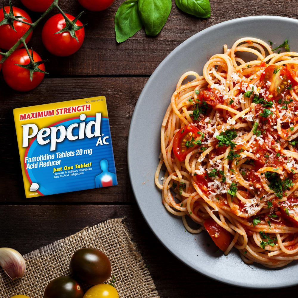 Pepcid AC office desk pack sits beside notebook for on-demand heartburn control.