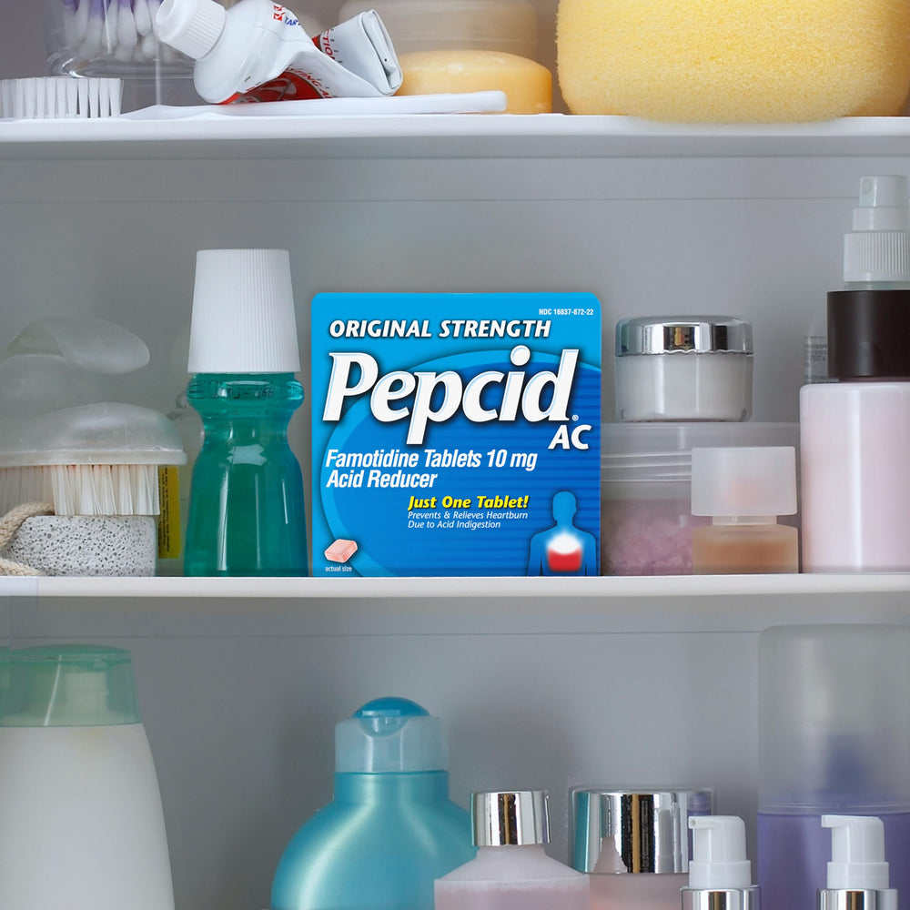 Pepcid AC Original Strength at a desk, ready for quick heartburn prevention.