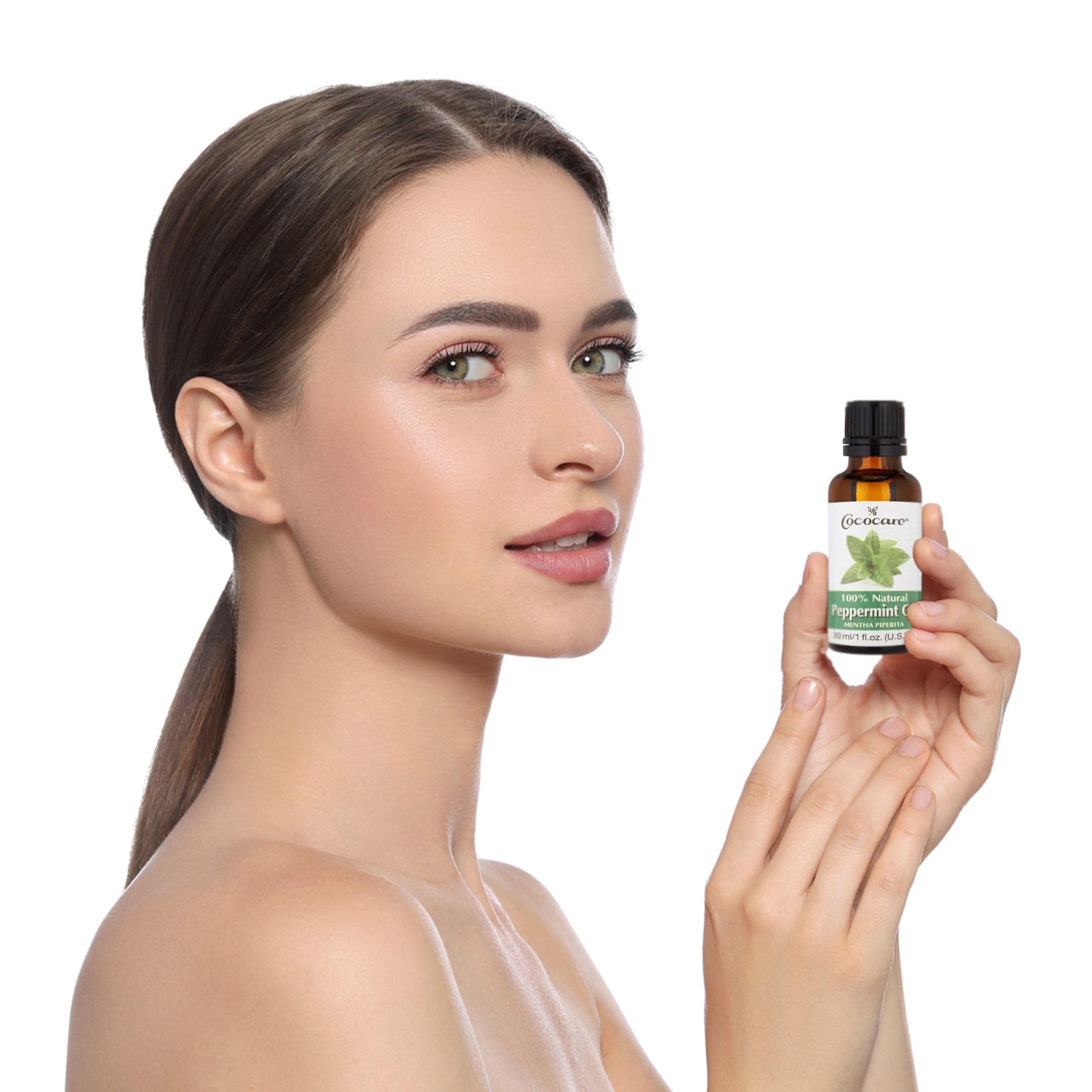 Peppermint oil bottle with fresh mint leaves