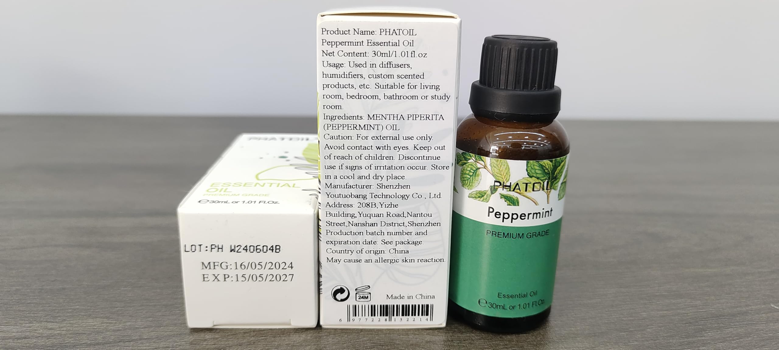 Close-up of peppermint leaves with oil bottle