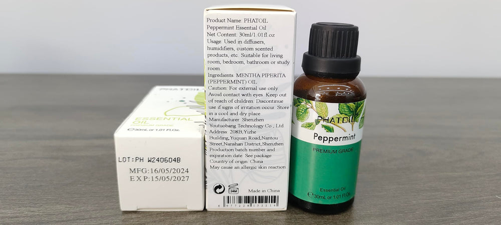 Close-up of peppermint leaves with oil bottle