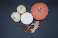 PeripetiHome pumpkin-ginger candle setting enhances dining room autumn mood.
