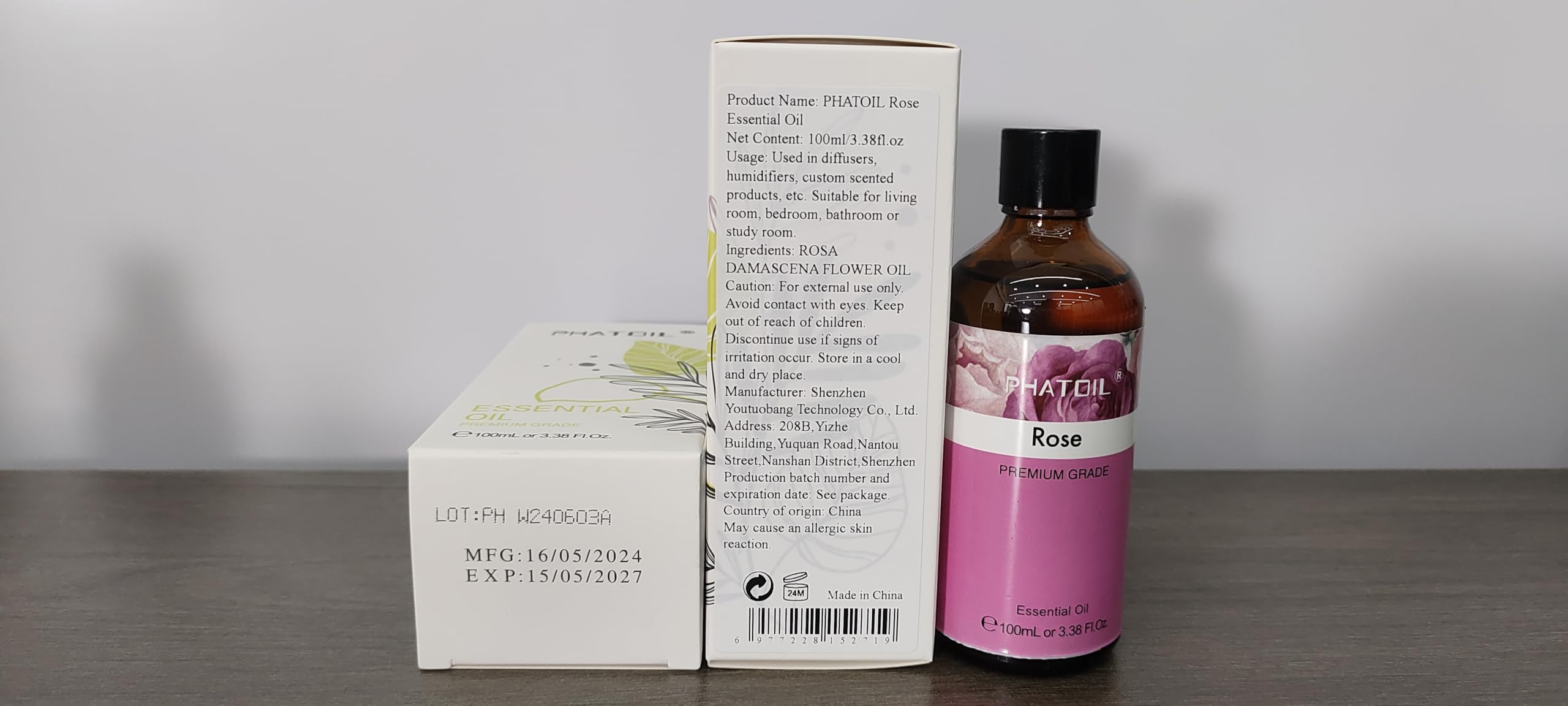 Close-up of PHATOIL rose essential oil bottle