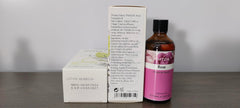 Close-up of PHATOIL rose essential oil bottle
