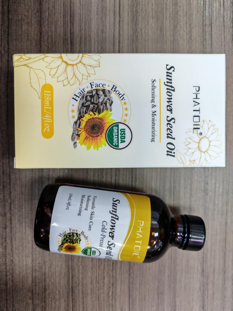 Dropper dispensing sunflower seed oil from the bottle