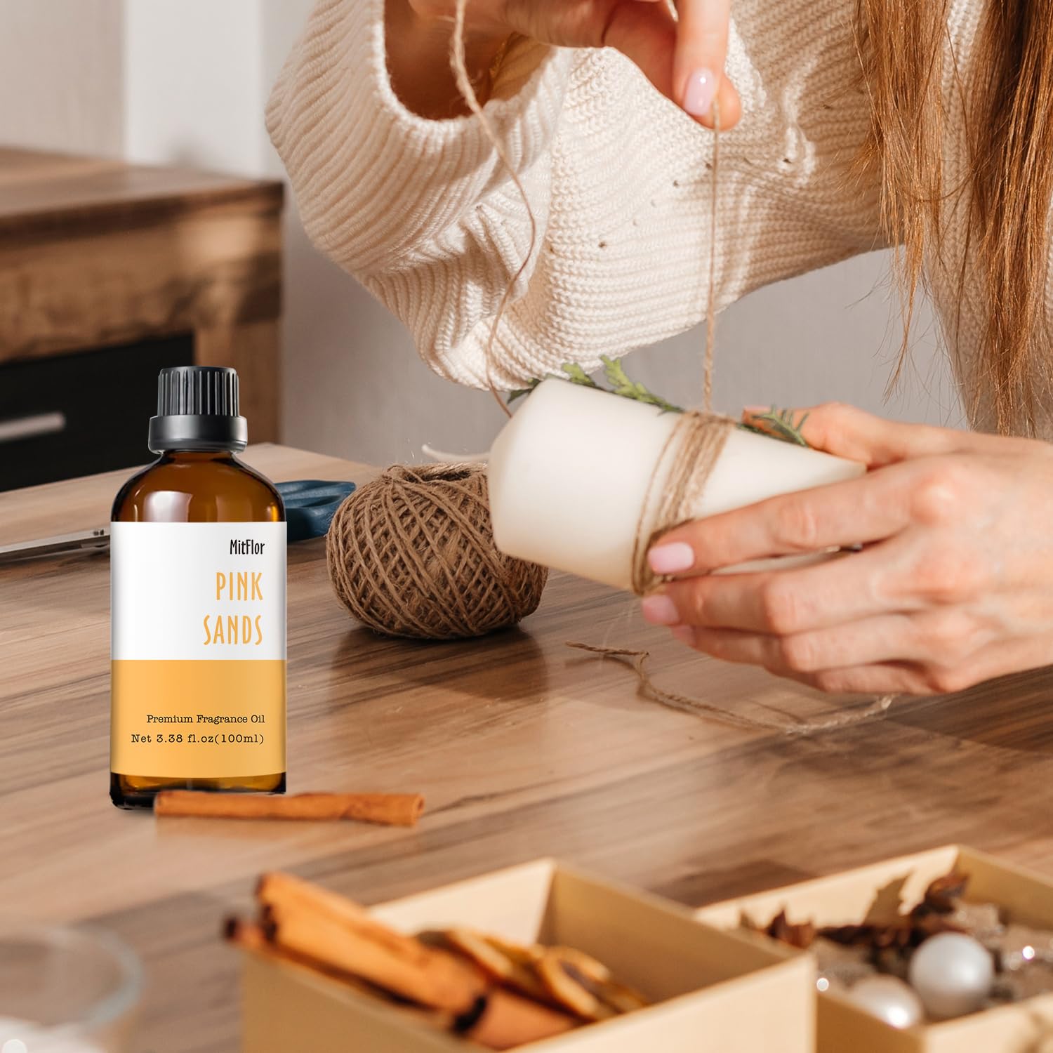 Flat lay of Pink Sands fragrance oil with minimalist gift box