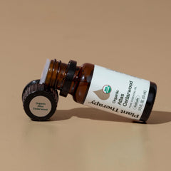 Cedarwood essential oil bottle with cedarwood wood imagery