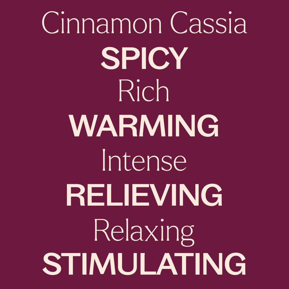Cinnamon Cassia essential oil bottle resting on a wooden surface