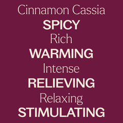 Cinnamon Cassia essential oil bottle resting on a wooden surface