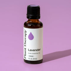 Lavender essential oil bottle with 30 mL label on a wooden surface