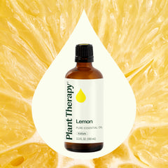 Lemon essential oil bottle on a white background