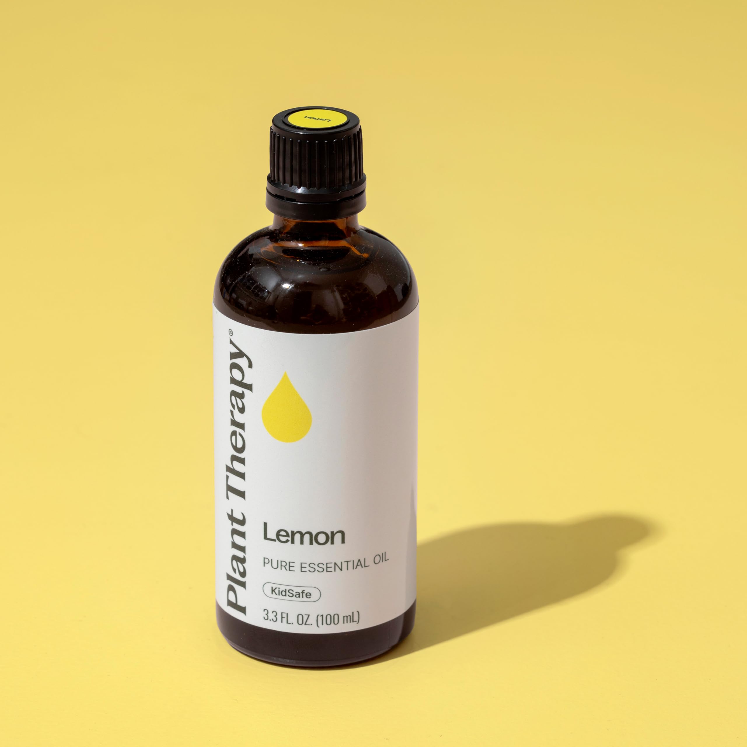 Lemon essential oil bottle with label showing 100% pure