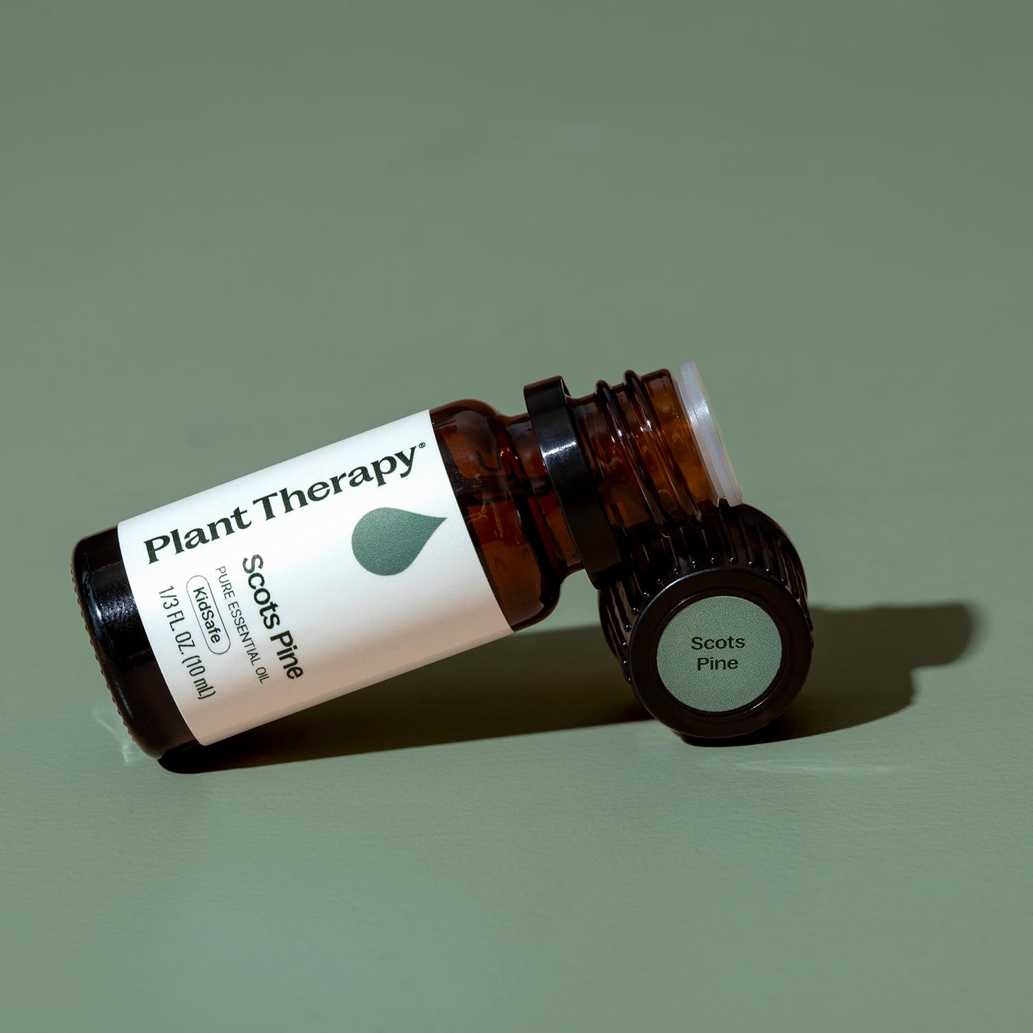 Hands applying essential oil massage to skin