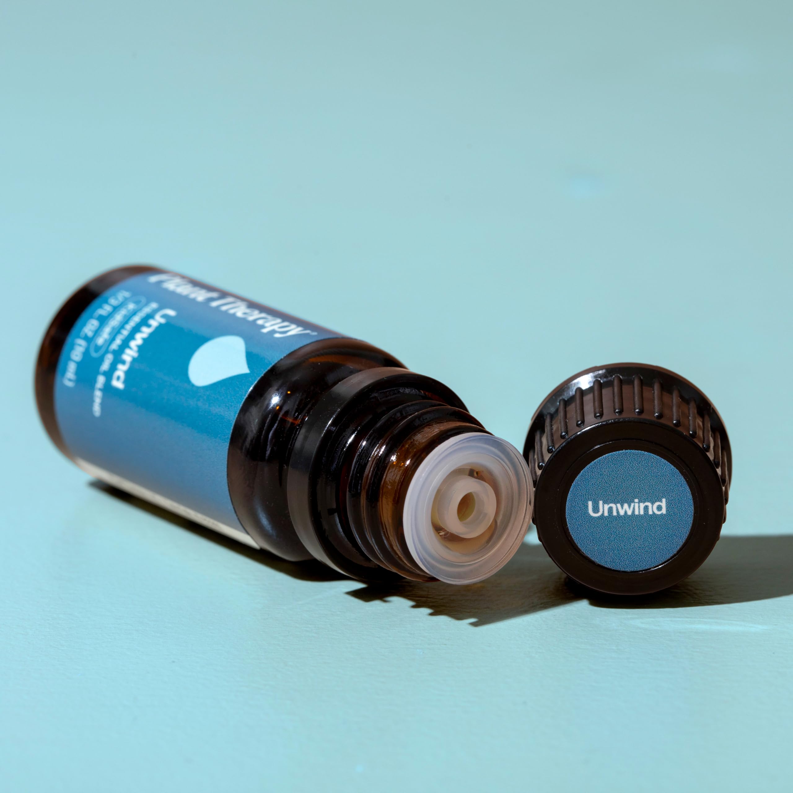 Unwind essential oil blended with a carrier oil for massage