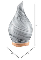 Close-up of hand-blown glass globe and wooden base diffuser