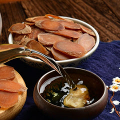 Porcelain bowl with ginseng slices ready for steaming