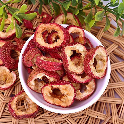 Hand-sliced hawthorn fruit dried to brown-red color