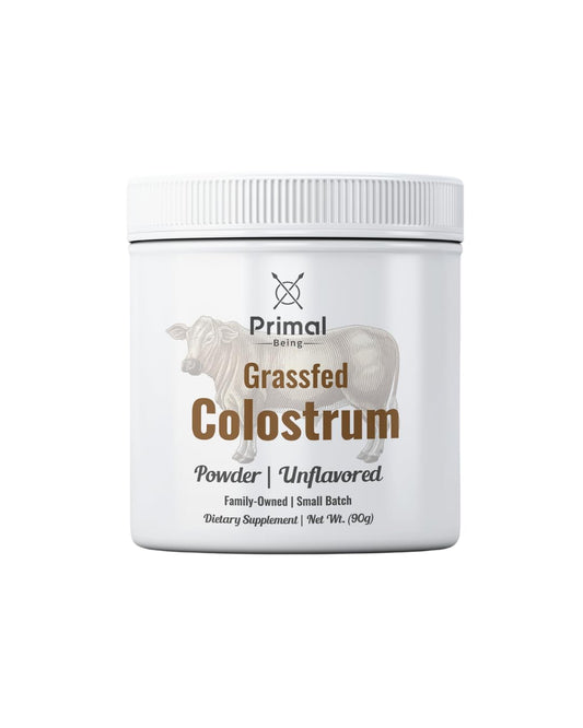 Primal Being Grassfed Colostrum Powder 90 g with scoop on white background