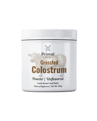 Primal Being Grassfed Colostrum Powder 90 g with scoop on white background