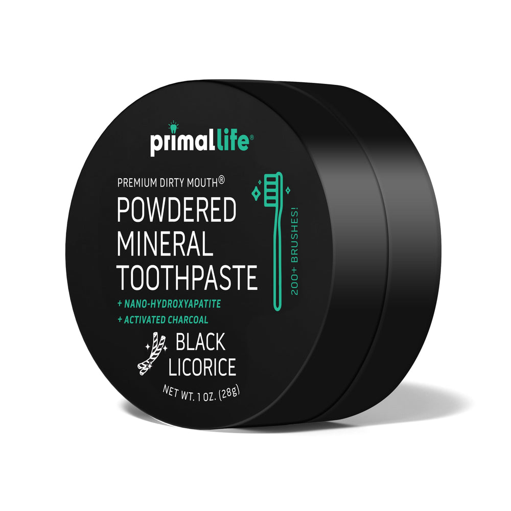 Toothpowder on toothbrush with Charcoal Black Licorice flavor