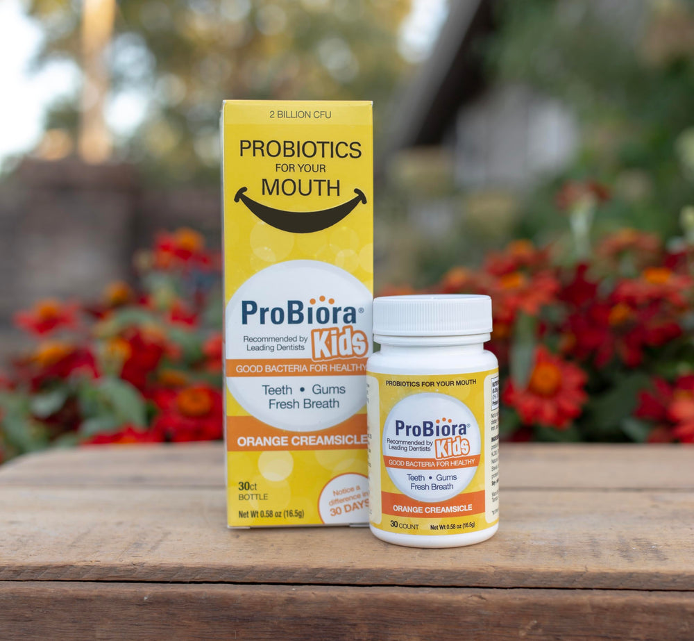 Happy child with healthier teeth and gums after using ProBiora Kids