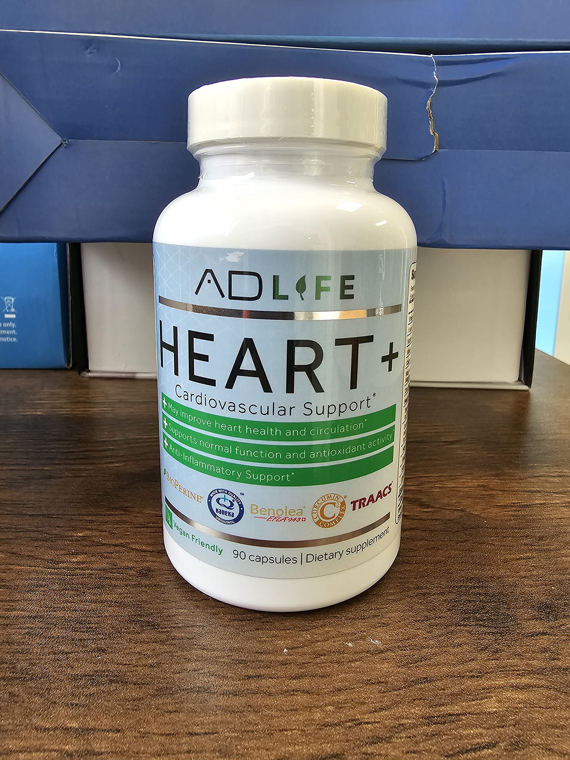 Heart+ capsules on white background