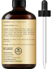 Pouring pumpkin seed oil from glass bottle