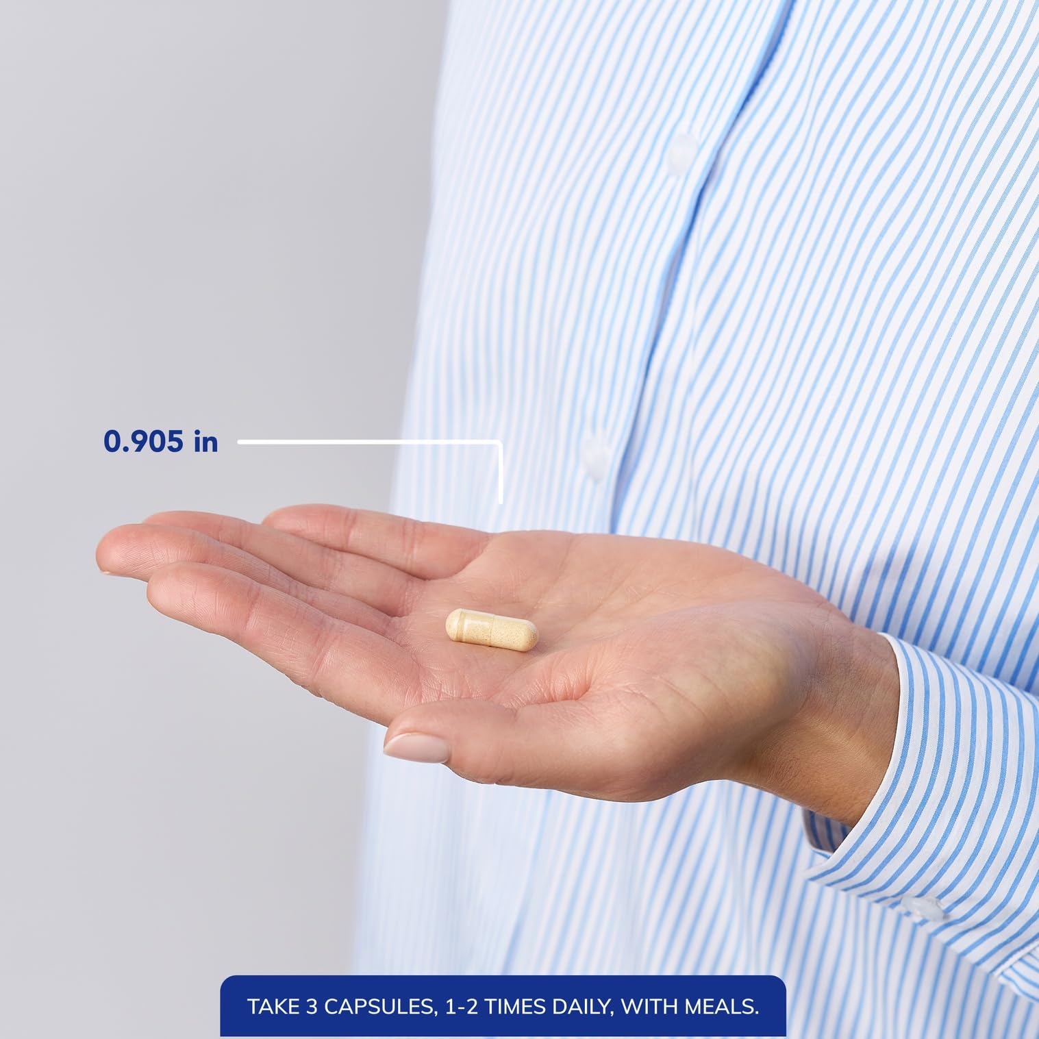 Bottle with capsules spilled on white background