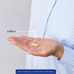 Bottle with capsules spilled on white background