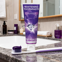 Toothbrush applying purple whitening toothpaste