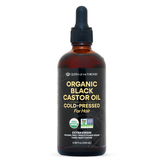 Amber glass bottle of Queen of the Thrones Organic Black Castor Oil with dropper