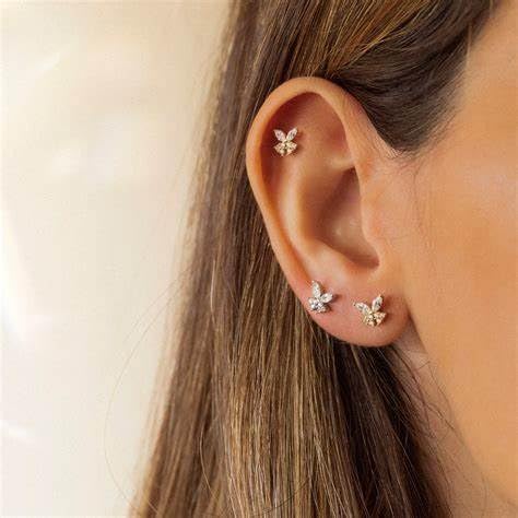 QWALIT waterproof earmuffs protect skin during piercing sessions.