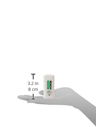 Applying Reach Mint Waxed Floss to clean between teeth