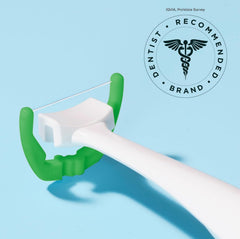 Person flossing with mint-flavored Reach refill heads