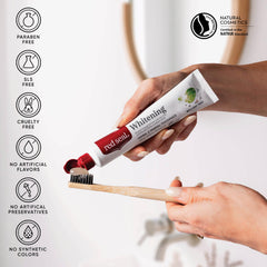 Mint toothpaste being squeezed onto a toothbrush