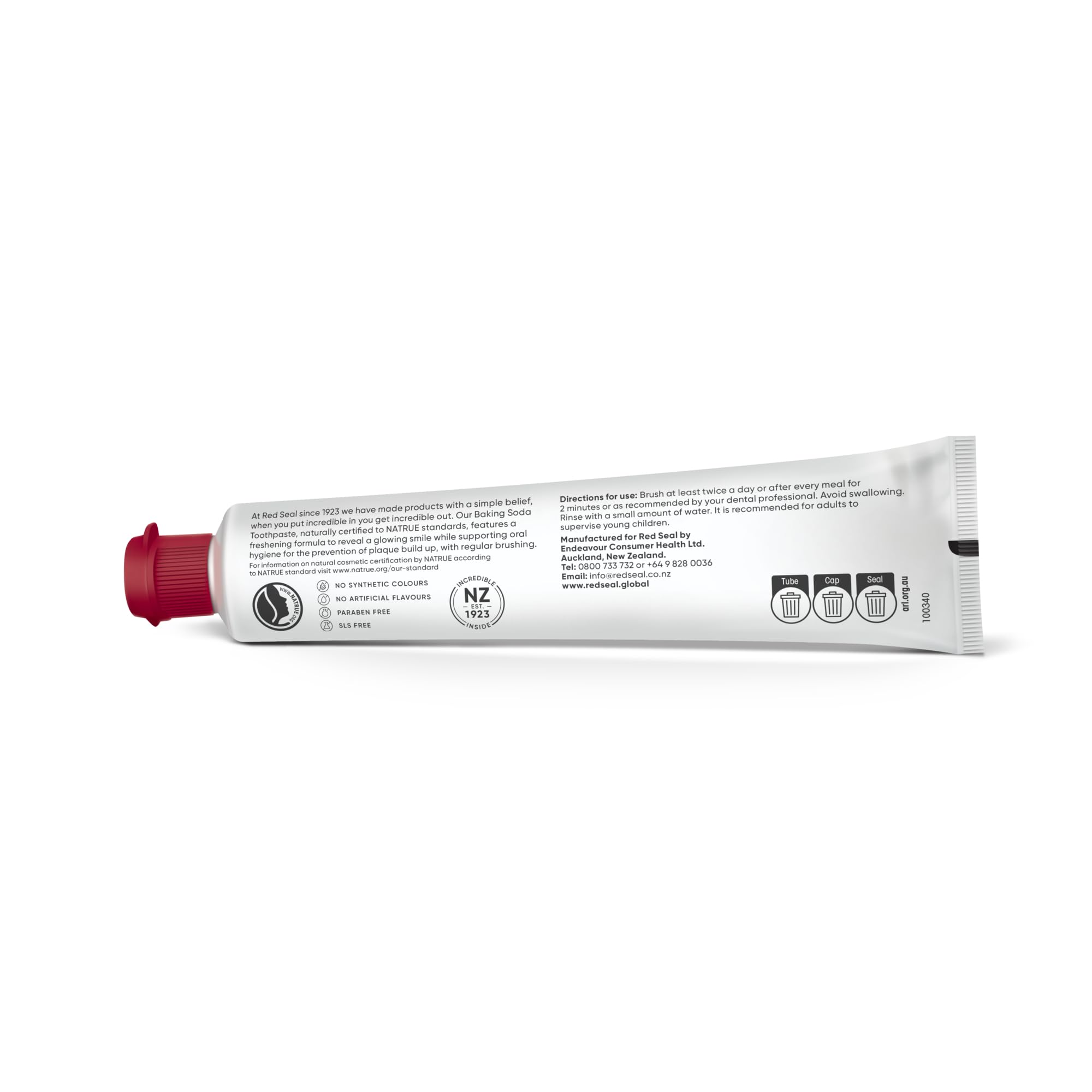 Smiling person showing clean teeth after brushing with Red Seal toothpaste