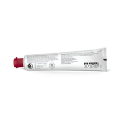 Smiling person showing clean teeth after brushing with Red Seal toothpaste